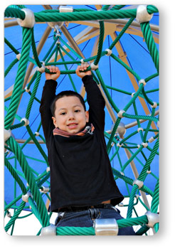 Boy Hanging Onto Rope