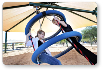 Two girls swinging on a Biggo Tres