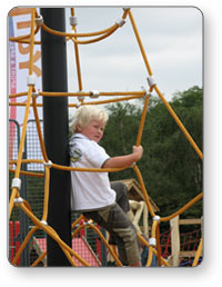 Child Leaning on Net Climber Post