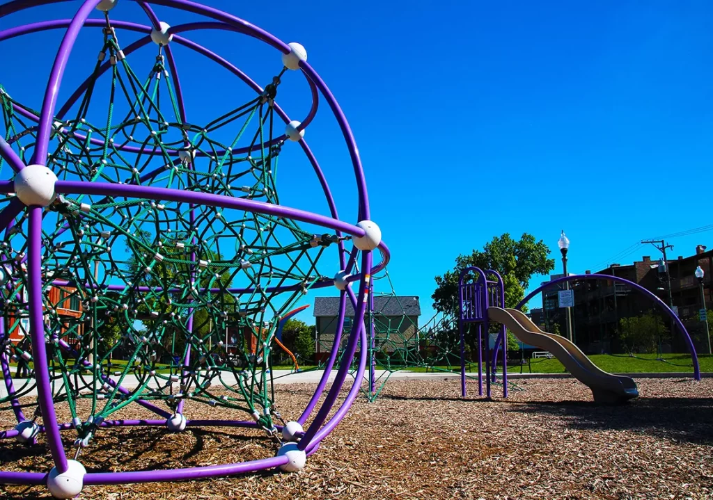 playground with rope climbing dome and slide